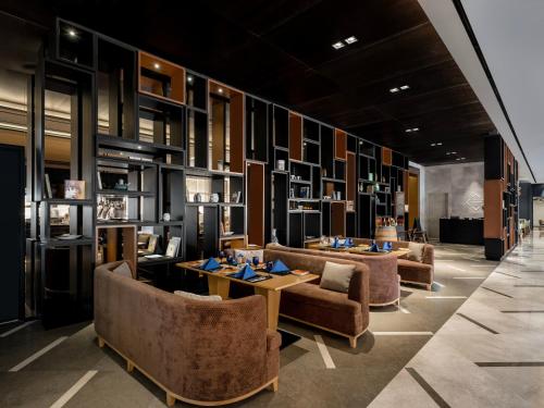 a restaurant with couches and tables in a room at Novotel Ambassador Seoul Yongsan in Seoul