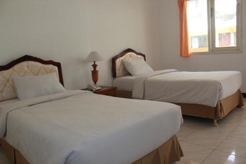 Voodi või voodid majutusasutuse Mega Bintang Sweet Hotel 2 toas