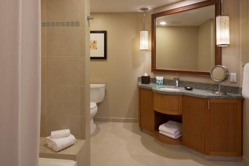 a bathroom with a sink and a toilet and a mirror at Hyatt Vacation Club at Ka'anapali Beach in Lahaina
