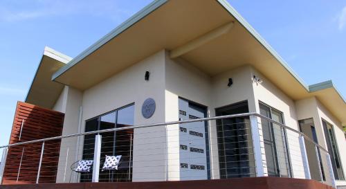 a large white building with a balcony at Ou+look BnB in Rosevears