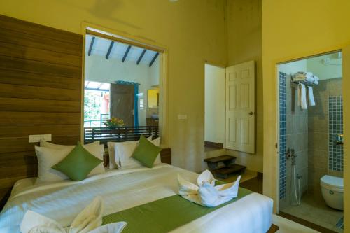 A bed or beds in a room at Letstay Adithya Nature Resort & Spa