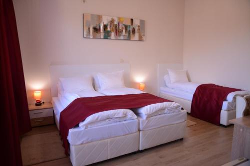 a bedroom with two beds and two lamps on the floor at Hotel Afrodita Dimitrovgrad BG in Dimitrovgrad