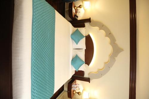 a mirror hanging on a wall with a clock at Comfort Inn Sapphire - A Inde Hotel in Jaipur