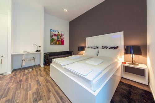 a bedroom with a large white bed with white sheets at Priuli Luxury Rooms in Split