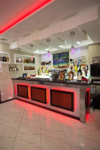 a bar in a restaurant with red lights at Hotel Palma in Rinas