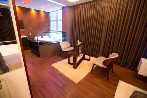 a room with a table and two chairs and a desk at Hotel Palma in Rinas