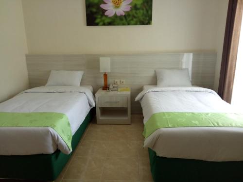Кровать или кровати в номере Green Garden Hotel