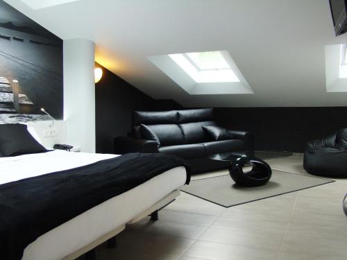 a bedroom with a bed and a couch and a skylight at Bekale in Ea