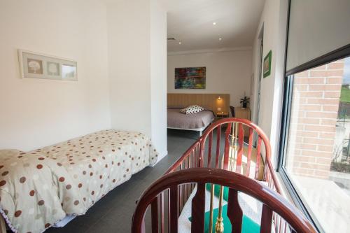 a small bedroom with a bed and a balcony at Hotel La Tavernetta in Campobasso