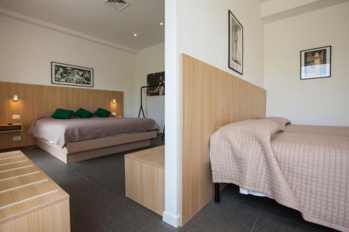 a hotel room with two beds in a room at Hotel La Tavernetta in Campobasso