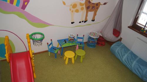 a childs play room with a table and a tent at Penzion Pribisko in Zuberec