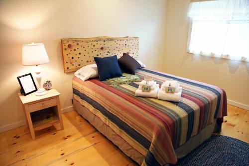 a bedroom with a bed with two stuffed animals on it at Trailside Inn in Killington