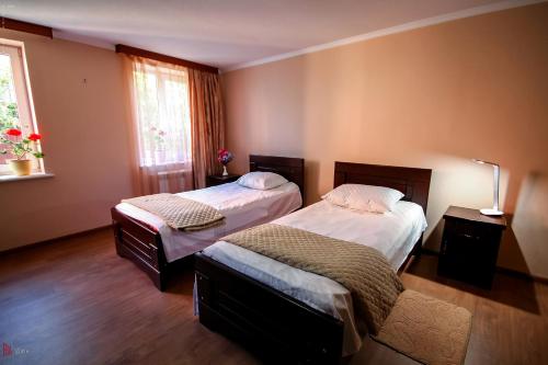 Postel nebo postele na pokoji v ubytování Green Garden Guest House