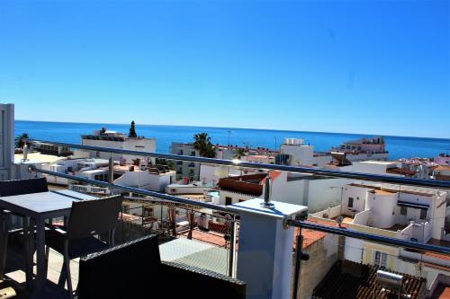 a balcony of a building with a view of the ocean at Hostal Don Peque Adult Recommended in Nerja