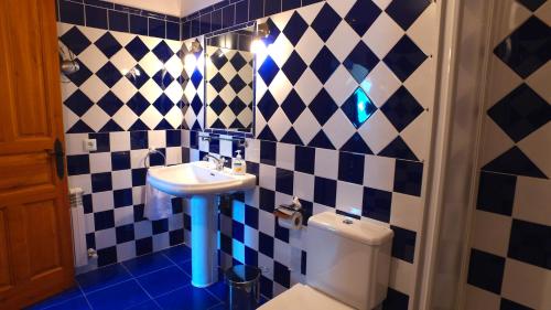 a bathroom with a sink and a toilet at Apartamentos Rurales Pedredo in Pedredo