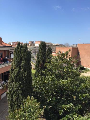 two trees on the balcony of a building at EH Suites Rome Airport Euro House Hotels in Fiumicino