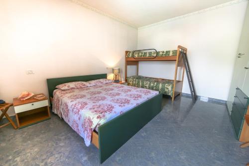 a bedroom with a bed and a bunk bed at La Casa sul Lago d'Iseo in Sulzano