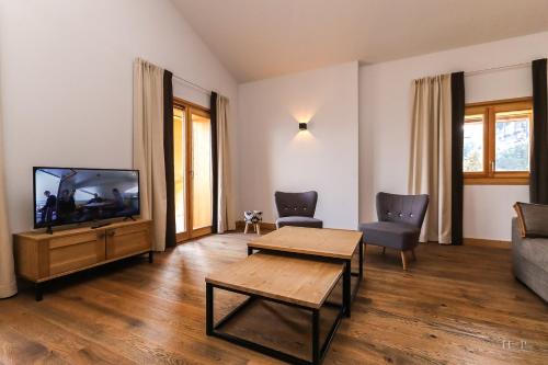 a living room with a couch and a tv at TERRESENS - Les Fermes du Mont-Blanc in Combloux