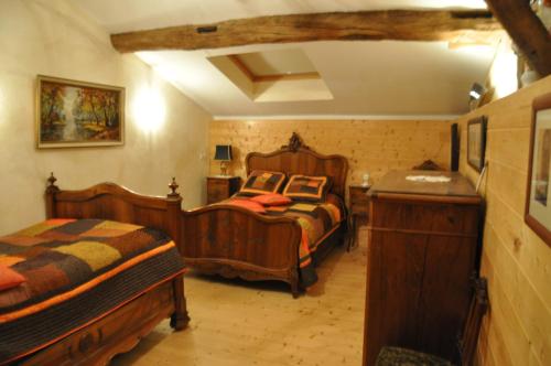 a bedroom with two beds and a table in it at Ferme Passion in Saint-Trivier-sur-Moignans