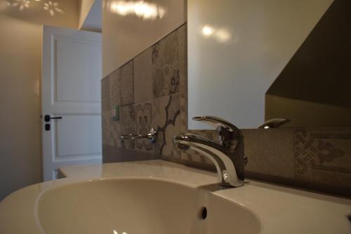 a bathroom with a sink and a faucet at Agriturismo Villa Gaia in Modica