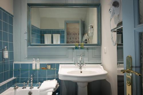 a bathroom with a sink and a mirror at Château de La Ballue - Teritoria in Val Couesnon