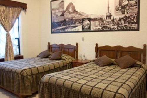 Postel nebo postele na pokoji v ubytování Hotel Don Porfirio