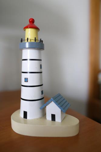 a toy lighthouse with a house on a table at La Casa sul Lago d'Iseo in Sulzano