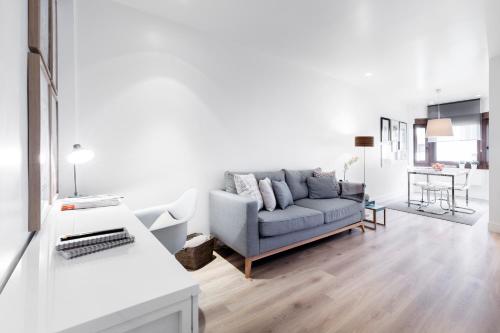 a living room with a couch and a table at Villanueva Apartments by Flatsweethome in Madrid