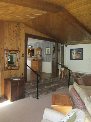 a living room with a couch and a table at Dodgeton Creek Inn in Cuchara