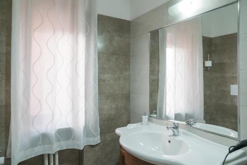 a bathroom with a sink and a shower curtain at B&B Posidonia Salerno in Salerno