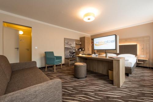 a hotel room with a bed and a television at Heikotel - Hotel Windsor in Hamburg