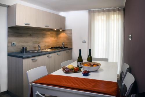 una cucina con un tavolo con una ciotola di frutta sopra di Guesthouse Lago di Nicito a Catania