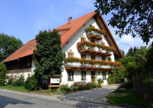 a large white house with flower boxes on it at Sporerhof in Murnau am Staffelsee