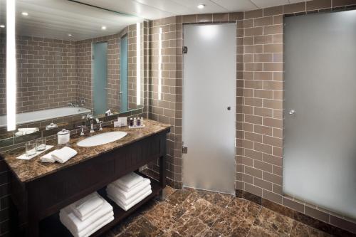 a bathroom with a sink and a mirror at Columbus Hotel Monte-Carlo, Curio Collection by Hilton in Monte Carlo