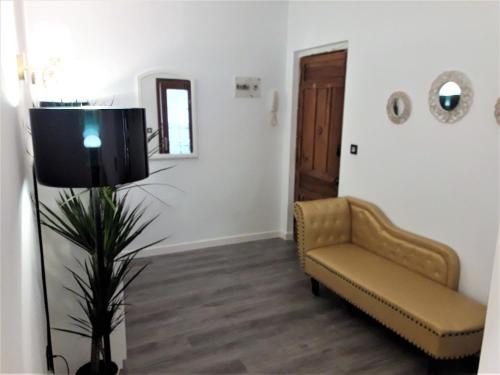 a living room with a couch and a chair at Apartamentos Sol Compañia in Úbeda