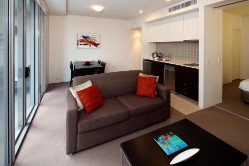 a living room with a couch and a table at Cairns Private Apartments in Cairns