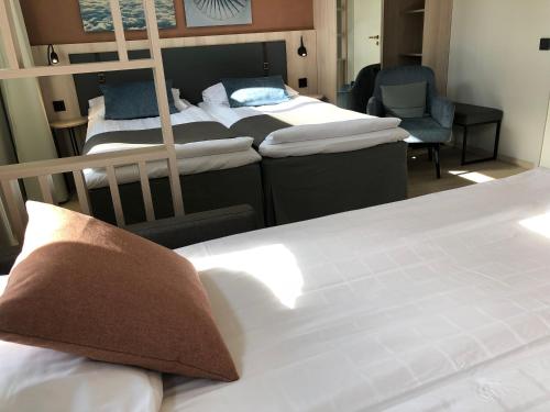 a bedroom with three bunk beds and a chair at Pilot Airport Hotel in Vantaa