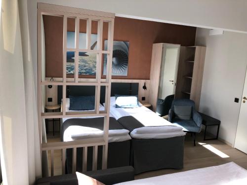 a bedroom with two beds and a bunk bed at Pilot Airport Hotel in Vantaa
