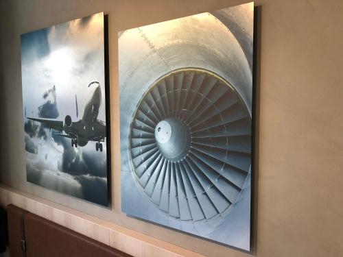a picture of a turbine on a wall with two pictures at Pilot Airport Hotel in Vantaa