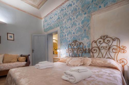 a bedroom with a bed with towels on it at Novella House in Florence
