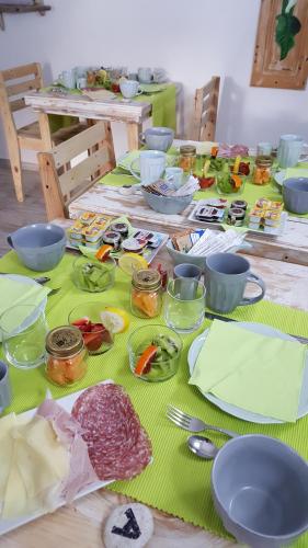a table with plates of food on top of it at B&B Les Chambres Rooms & Suite in Santa Teresa Gallura