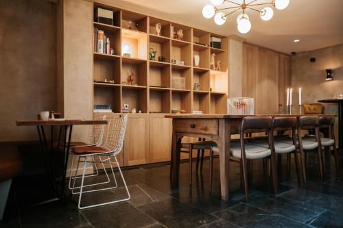 a kitchen with a wooden table and chairs at The Times Hotel in Amsterdam