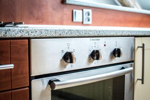 a stainless steel oven in a kitchen with a counter at Tylova Apartments in Kutná Hora