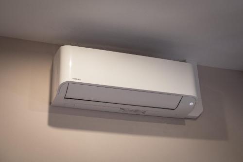 a white tv hanging on a wall at Tylova Apartments in Kutná Hora