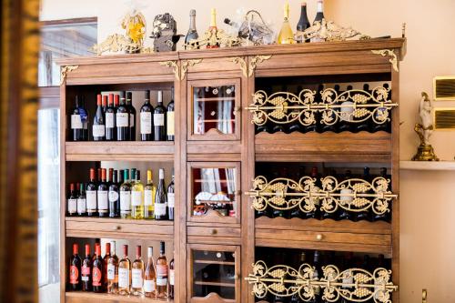 a wooden cabinet filled with lots of bottles of wine at Elegant Lux Hotel in Bansko