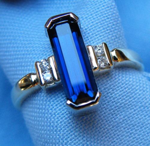 a blue sapphire and two diamonds in a ring at Rubyvale Motel & Holiday Units - An Adults Only Getaway in Rubyvale