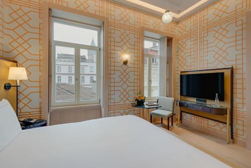 
a hotel room with a large bed and a television at The Galata Istanbul Hotel MGallery in Istanbul
