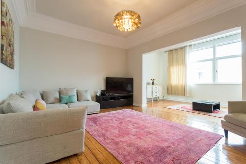 a living room with a couch and a tv at Cruz Apartments in Lisbon