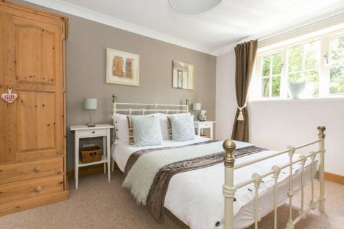 a bedroom with a white bed and a window at Annora House in Berkswell