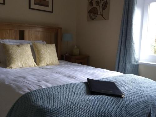 a black book sitting on top of a bed at The Old Rectory Bed and Breakfast in Ruthin